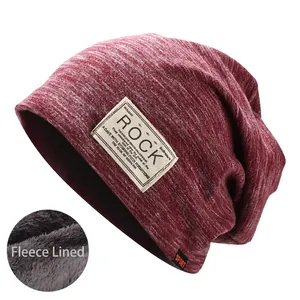 Detail of burgundy knitted beanie with warm fleece lining and ROCK logo patch