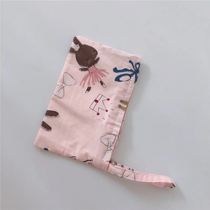 Close-up of pink cotton fabric phone pouch featuring cute cartoon rabbit prints and handle