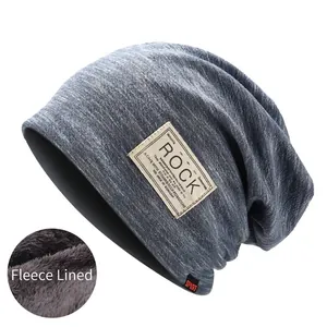 Detail of the thick grey fleece lining inside the knitted beanie for winter warmth