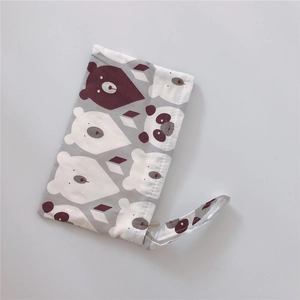 Close-up of cotton wristlet pouch featuring cartoon bear and panda patterns