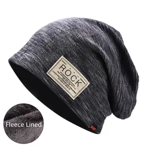 Detail of heather grey beanie with warm fleece lining and vintage patch decoration
