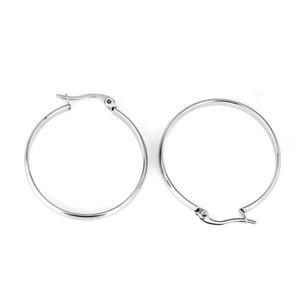 Macro detail of silver stainless steel hoop earrings with polished metallic surface