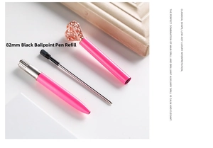 Detail view of pink metal ballpoint pen with rose gold heart charm and 82mm black ink refill