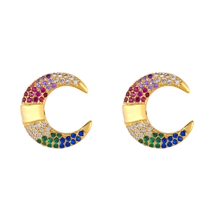 Detailed macro view of gold-tone crescent moon stud earrings with colorful cubic zirconia