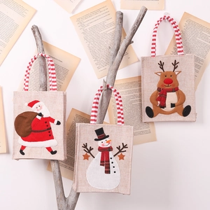 Linen Christmas gift bags featuring Santa, Snowman, and Reindeer designs with striped handles