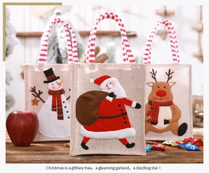 Detailed close-up of linen Christmas gift bags with Santa, Snowman and Reindeer embroidery