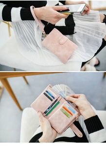 Detailed interior of a pink frosted suede trifold wallet with card slots and coin pocket