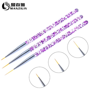 Macro details of 3-piece nail art brushes with glitter acrylic handles and fine liner tips