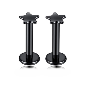 Detail of two black star-shaped labret studs with polished finish on white background