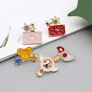 Detailed close-up of 5-piece enamel pin set featuring anime stars and magical girl charms