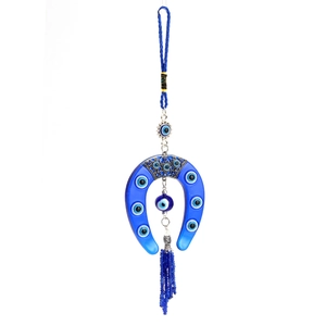 Detail of blue evil eye horseshoe ornament featuring decorative beads and hanging tassels