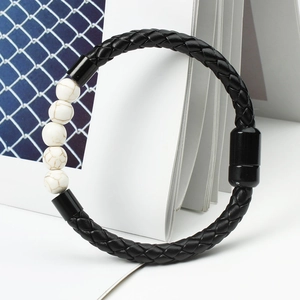 Detail of men's leather braided bracelet with white marble beads and magnetic clasp