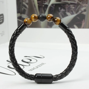Detail of men's braided leather bracelet featuring tiger eye stones and magnetic clasp