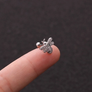 Silver bee stud earring with clear zircon and screw-back ball shown on fingertip