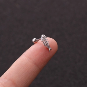 Silver stainless steel fishbone stud earring with clear zircon crystals on fingertip