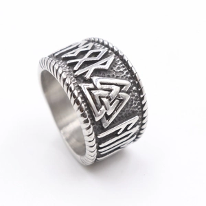 Macro detail of Nordic Valknut symbol and Viking runes on antique silver ring