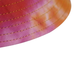 Close-up of vibrant gradient tie-dye bucket hat featuring precise yellow parallel stitching