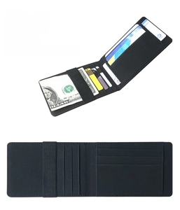 Close-up of black minimalist leather card wallet with elastic cash strap and card slots