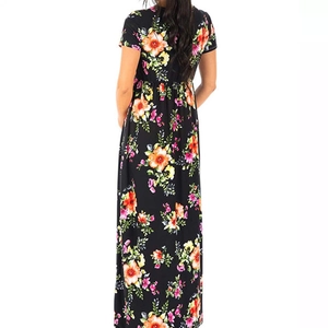 Back view of a high waist floral maxi dress in black with vibrant orange and red flower print
