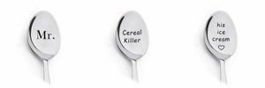 Macro detail of custom engraved silver stainless steel coffee spoons on white background