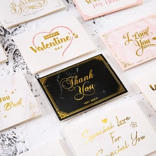 Flat lay of premium 3D greeting cards with gold foil lettering and various colors