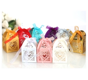 Close-up of assorted laser-cut heart candy boxes with ribbons in multiple colors