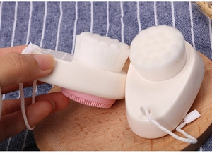 Close-up of dual-sided facial cleansing brush with soft bristles and silicone massager
