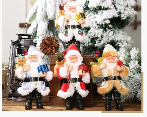 Detail of four colorful Santa Claus figurines in red, blue, white and gold festive outfits