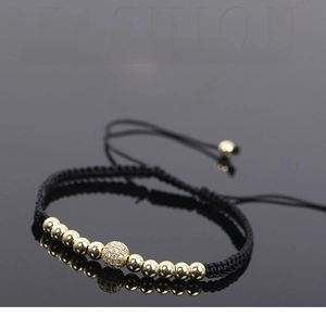 Detail of woven rope bracelet featuring gold pavé beads and black hematite stones
