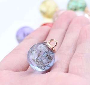 DIY glass ball pendant with white dried flowers and rose gold metal loop for jewelry