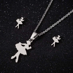 Detailed view of silver ballet girl pendant necklace and stud earrings set on black background