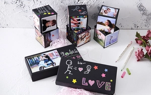 Detail of DIY exploding gift box with photos, hand-drawn greetings and pink decorative shred