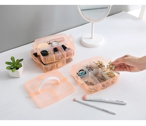 Detailed view of stackable pink plastic storage box with compartments and handle