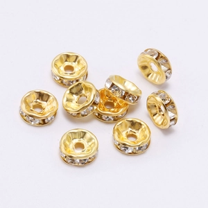 Detail of 9 golden rondelle spacer beads with inlaid clear crystals for DIY jewelry making