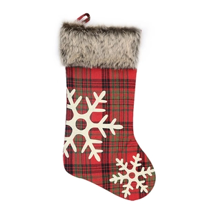 Classic red and green plaid Christmas stocking with faux fur trim and white snowflake patches