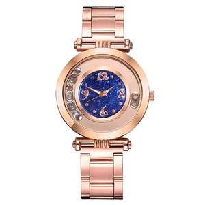Detail of rose gold ladies watch with starry blue dial and floating crystal accents