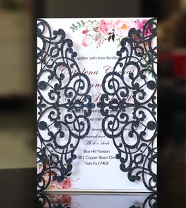 Laser-cut black glitter wedding invitation with floral insert and sharp hollowed edges