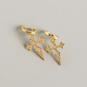 Macro shot of gold S925 silver cross hoop earrings with sparkling cubic zirconia stones