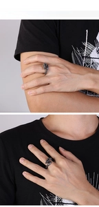 Detail view of vintage dragon head ring with adjustable open band on male hand