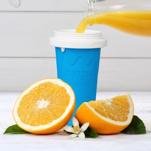 Blue silicone slushy maker cup Frozen Magic for DIY smoothies with orange juice