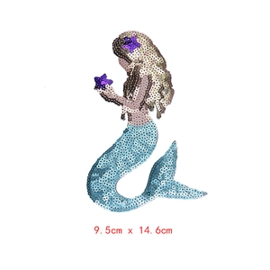 Detail of mermaid sequin patch in blue and gold showing 9.5cm x 14.6cm dimensions