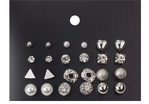 Macro view of 12 pairs of silver-tone stud earrings with pearls and crystals