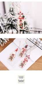 Close-up of wooden Christmas ornaments featuring hollow Santa and snowman designs