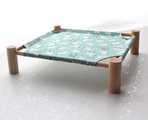 Detail of wooden pet hammock with mint green alpaca canvas and solid wood frame