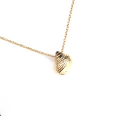 Close-up of a golden seashell pendant necklace with detailed metallic texture on white background