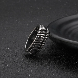 Vintage stainless steel motorcycle ring with textured tire pattern in silver and black finish