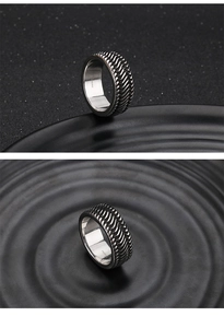Macro detail of men's stainless steel ring with black tire tread and silver inner band