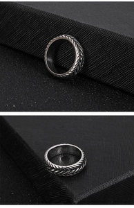 Macro shot of silver woven wheat pattern texture on a punk style stainless steel ring