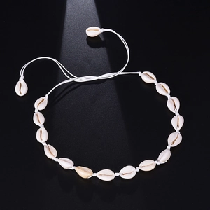 Handmade shell choker necklace with natural cowrie shells and adjustable woven cord