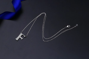 Close-up of S925 sterling silver letter F pendant necklace with pavé zircon details
